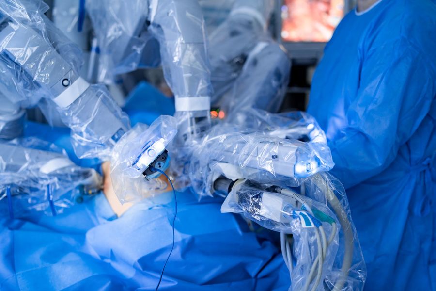 Multiple robotic arms in operating room.